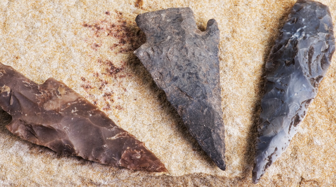 Three arrowheads on a stone.