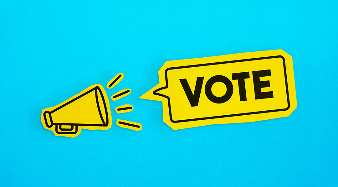 Illustration of yellow megaphone and speech bubble reading "Vote" on a bright blue background.