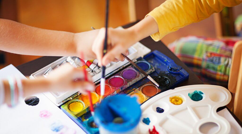 Close up image on children using different colours in art class, shallow depth of field