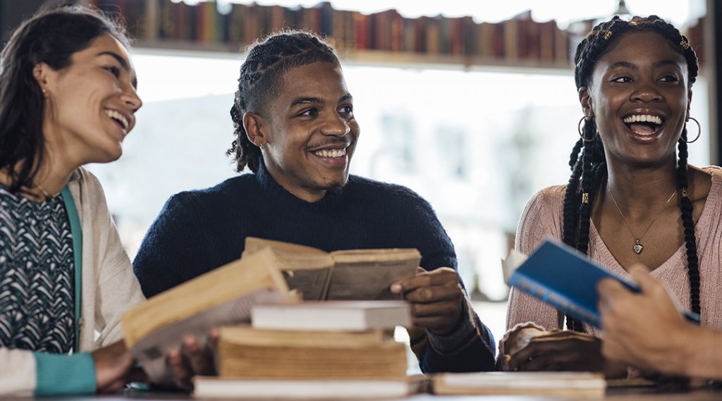 A medium shot of a multiracial group of adults in a book club.