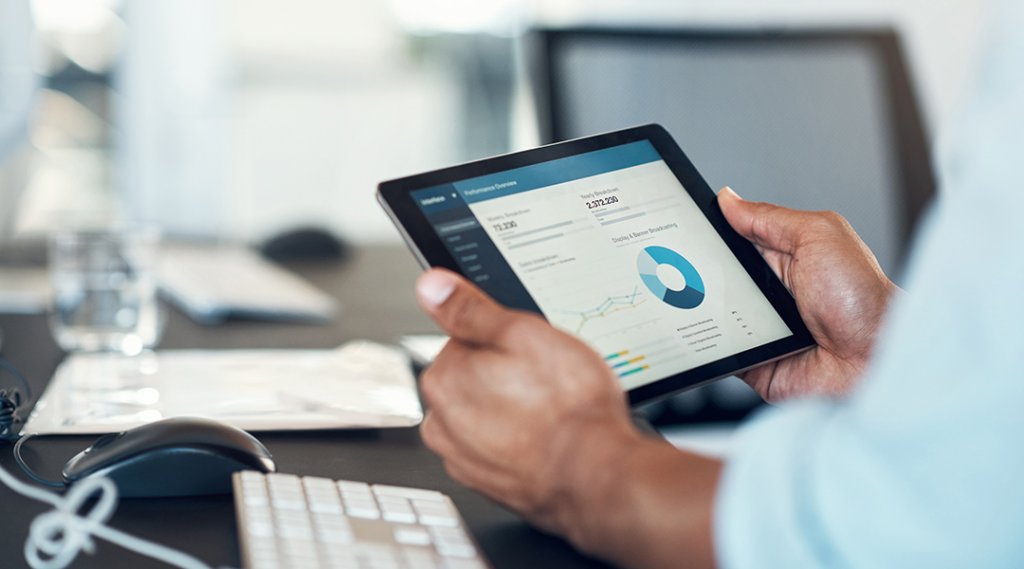 Cropped shot of a businessperson using a digital tablet to check investments.