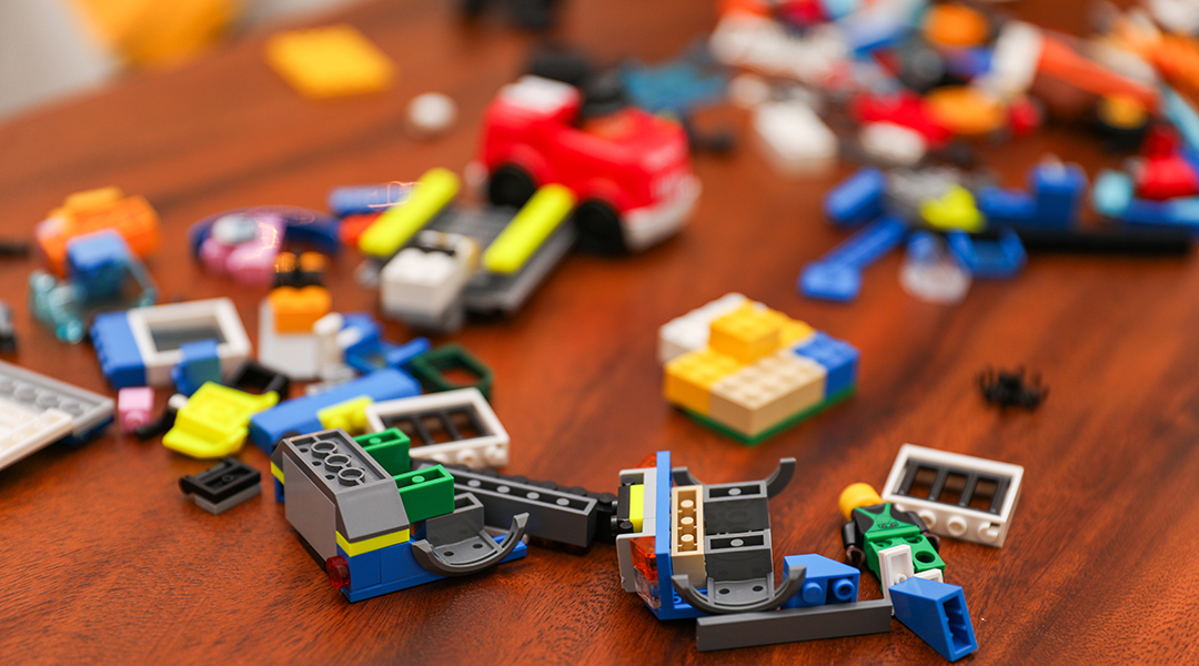 Close-up of an array of Legos and building blocks on a tabletop.