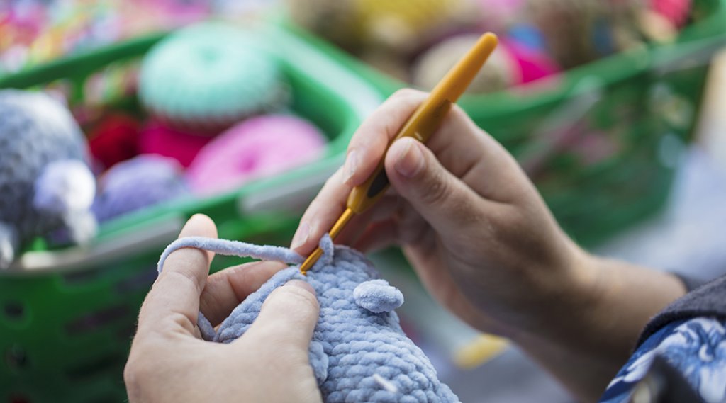 Close-up of a person doing crochet.