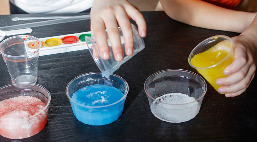 Children make experiments with paint and artificial snow