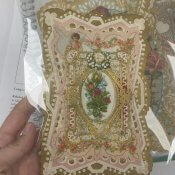 A Victorian Era die-cut Valentine's card adorned with paper lace and florals