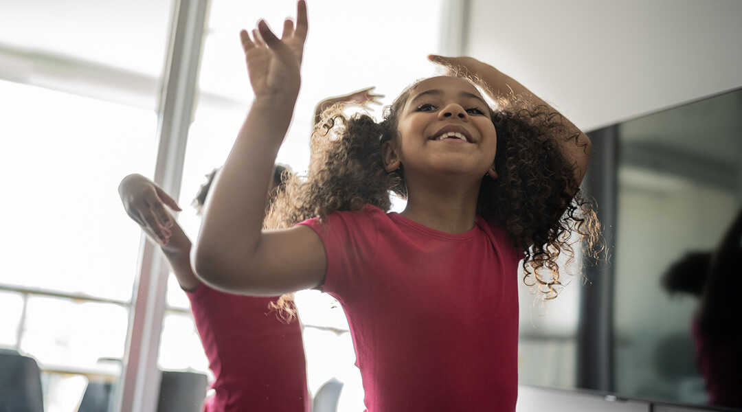 Young smiling girl dancing