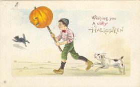 Postcard - illustration of a boy holding a jack-o-lantern on a stick with a dog and black cat running beside him. It says, "Wishing you a jolly Hallowe'en."