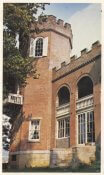 Brick building with a tower and turrets at the top, like a castle