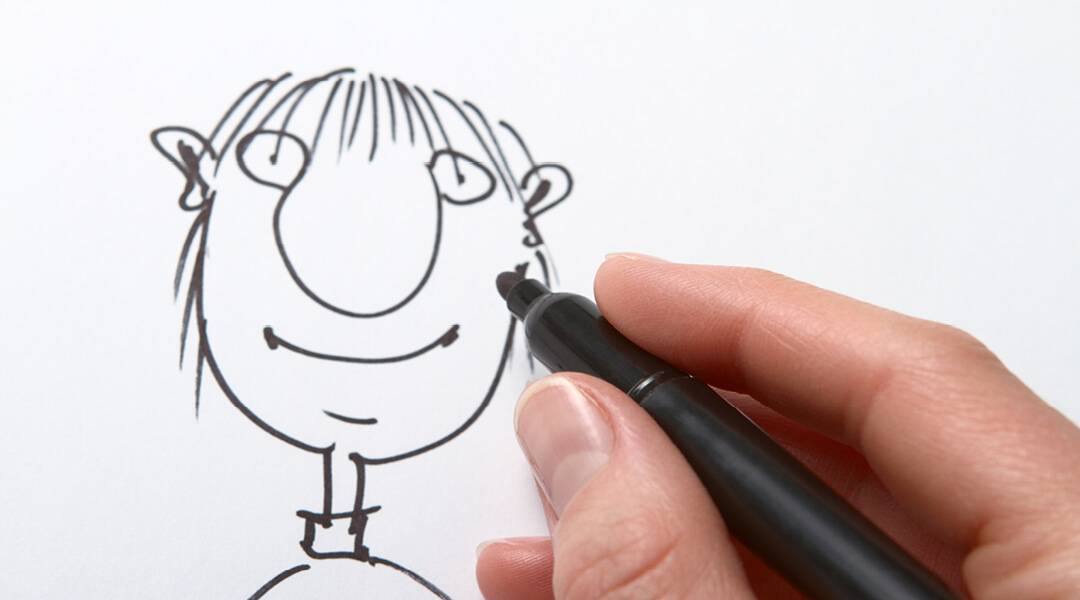 Close-up of a hand drawing a simple cartoon person.