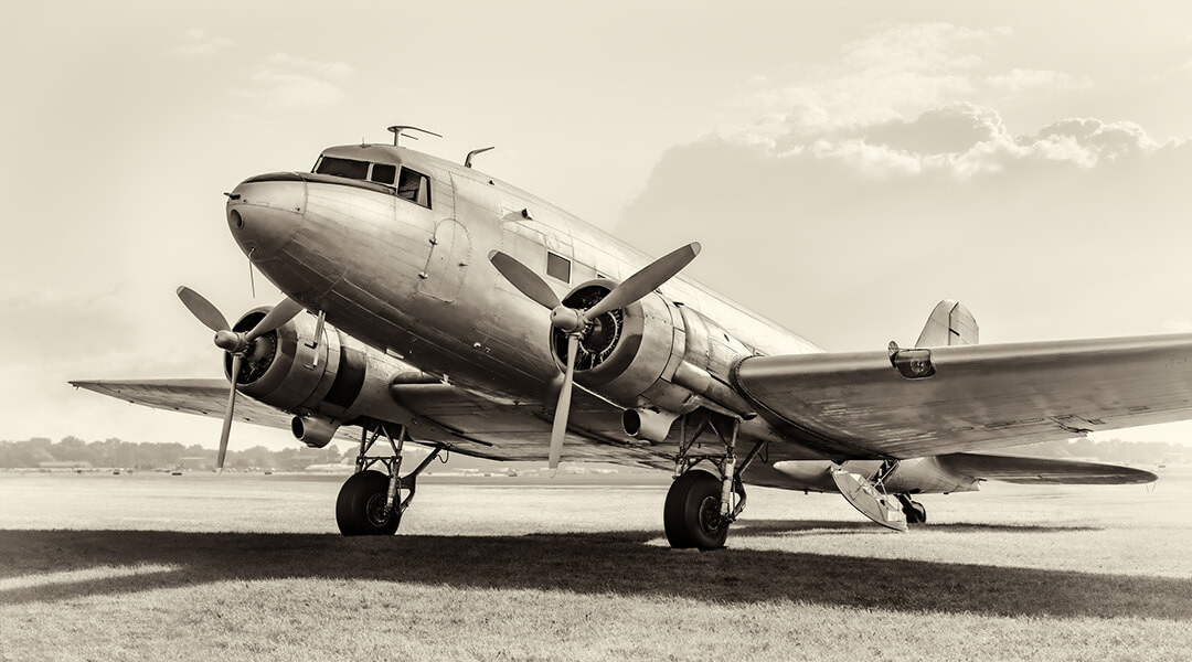 An old plane near an airfield.