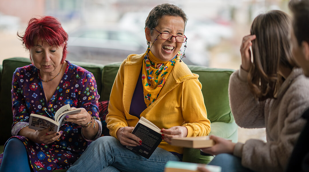 Diverse aged group of people reading books together